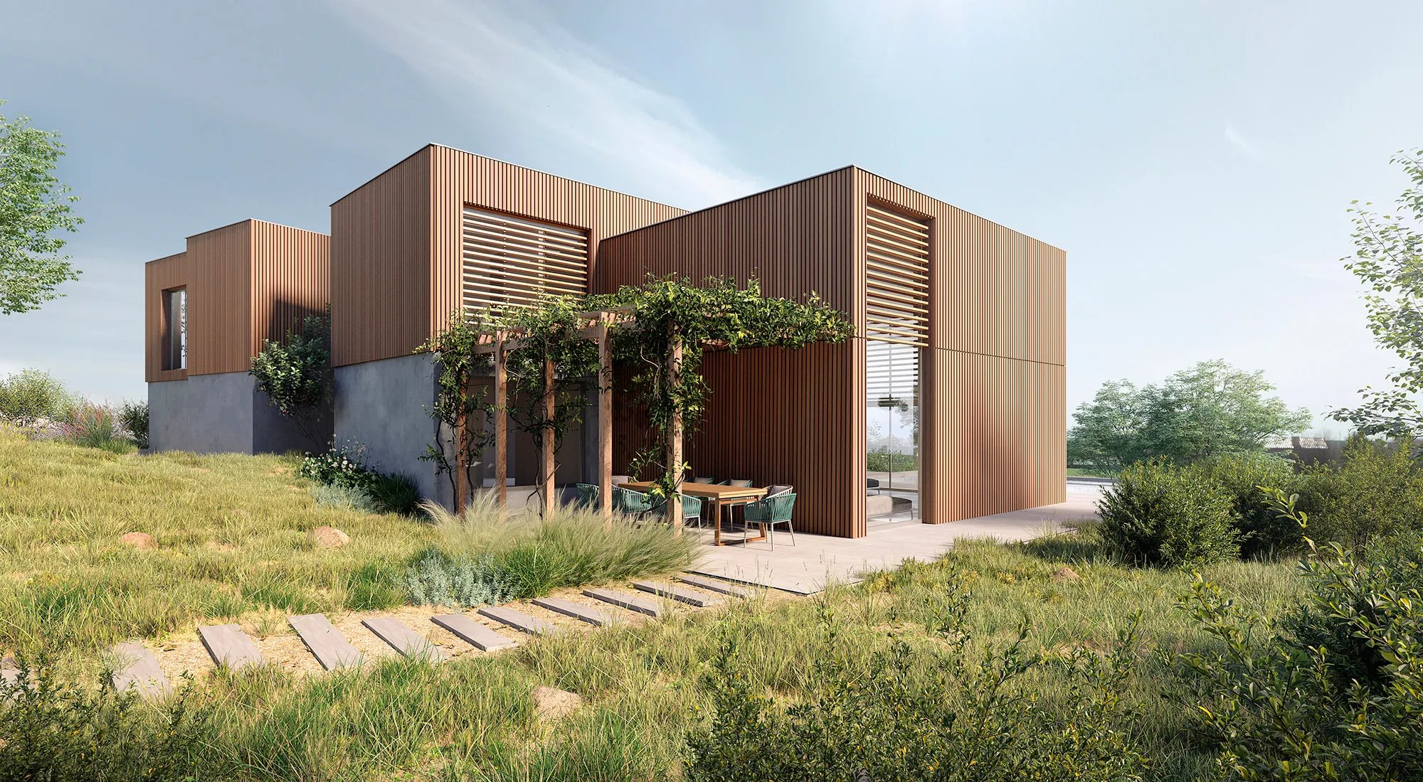 Fachada posterior con jardín mostrando el juego de volúmenes — planta superior de madera en listones sobre base de hormigón