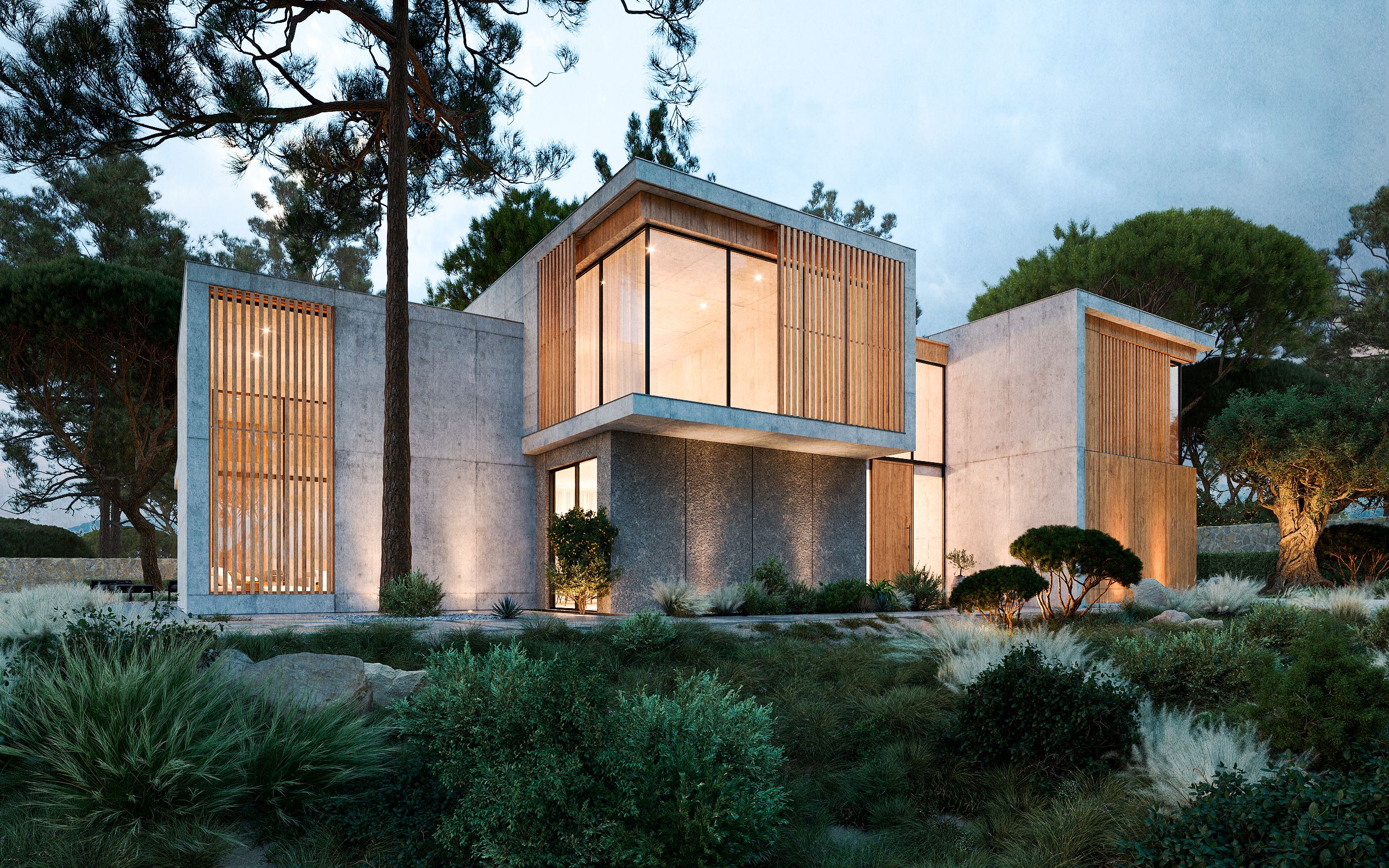 Diagonal view of the house at night, with stone, concrete and wood elements lit from within
