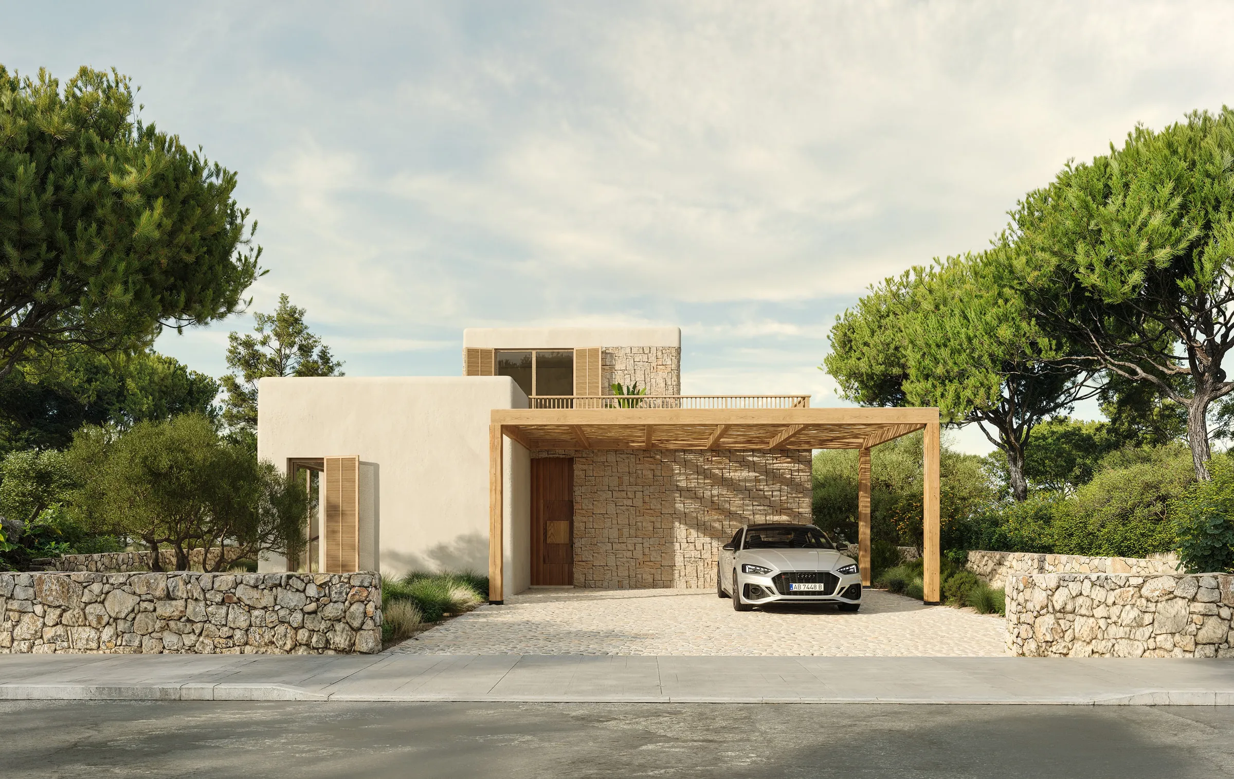 La villa vista desde la entrada, rodeada de pinos centenarios